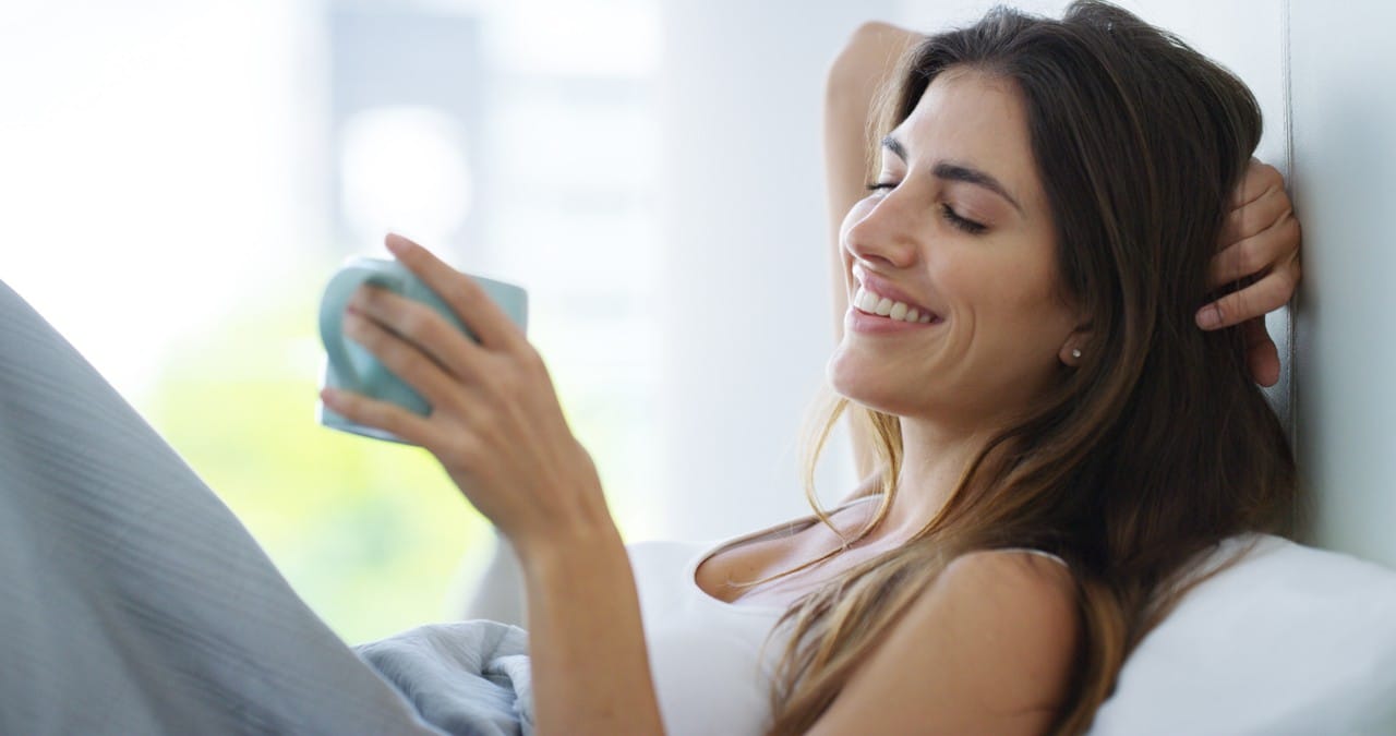 mulher tomando chá na cama